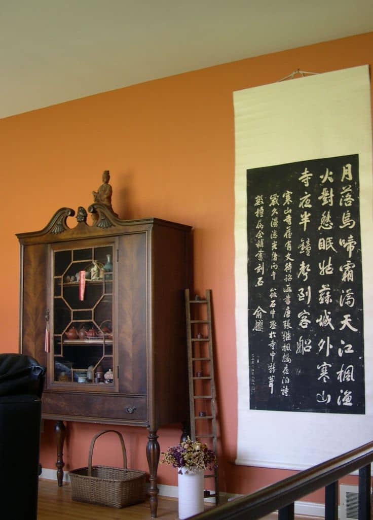 The artwork and furniture is highlighted by the color of the wall. 